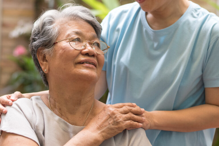 Caregiver, carer hand holding elder hand woman in hospice care. Philanthropy kindness to disabled concept.Public Service Recognition Week